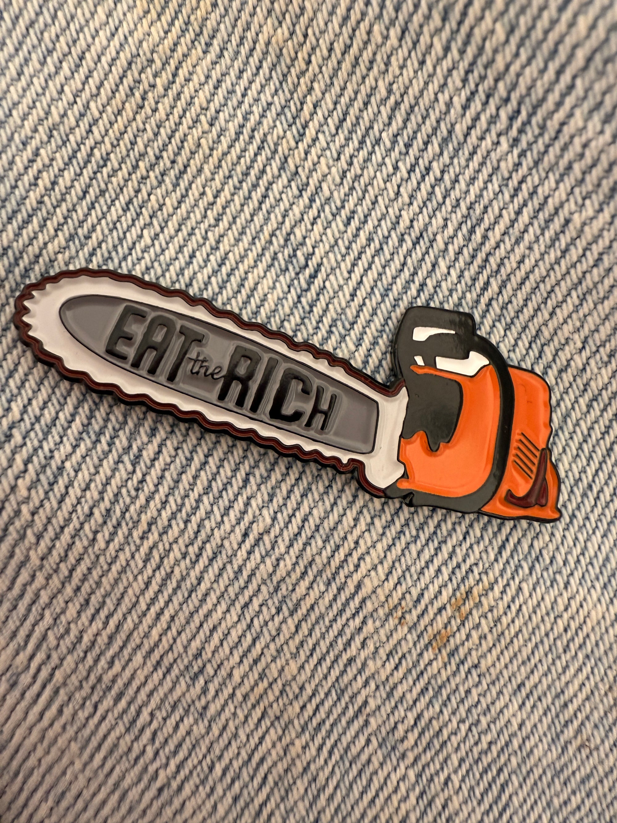Chainsaw of Democracy Eat the Rich Enamel Pin